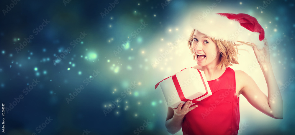 Happy young woman holding a present box Happy young woman holding a present box