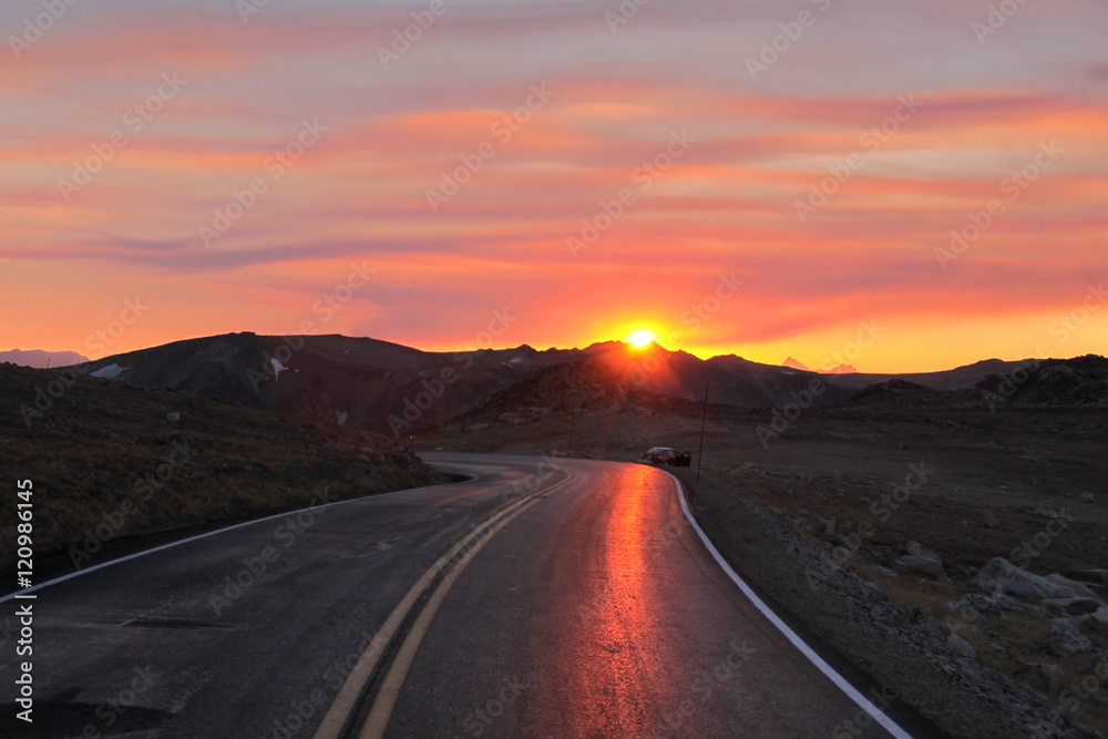Mountain road under sun set