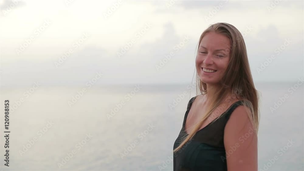 Beautiful girl enjoying the sun and sea at sunrise Beautiful girl enjoying the sun and sea at sunrise