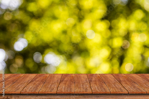 Wood table top on bokeh abstract background - can be used for mo