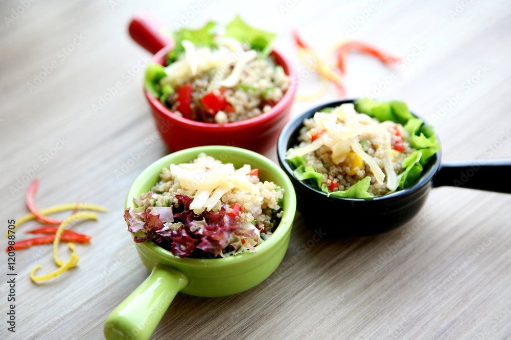 Claypot of colorful salad on wooden table in restaurant Claypot of colorful salad on wooden table in restaurant
