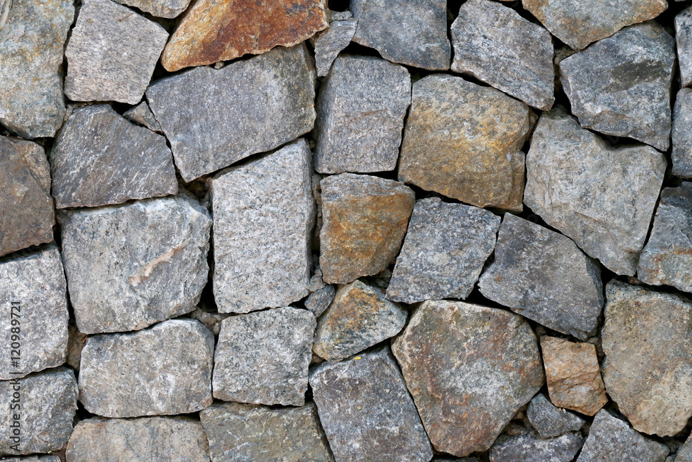 old stone wall Texture in weathered and have natural surfaces. old stone wall Texture in weathered and have natural surfaces.