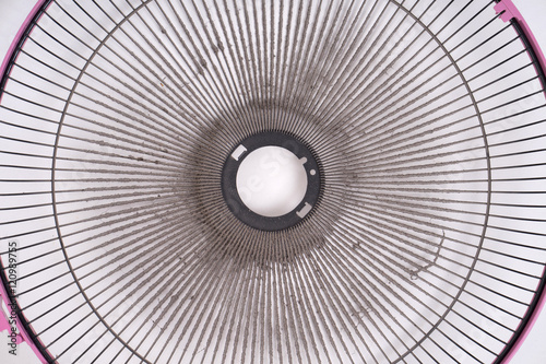 dirty electric fan on white background
