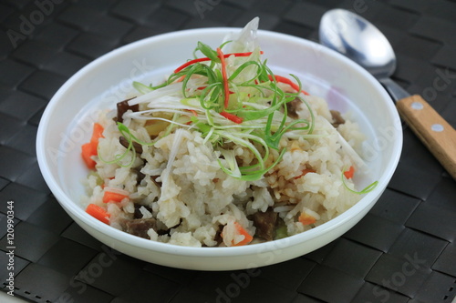 Special fried rice with pork and herbs on white bowl on the tabl