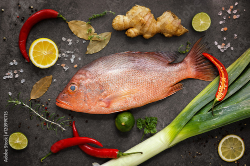 Fresh ingredients to cook fish, red snapper, leak, lime, lemon,