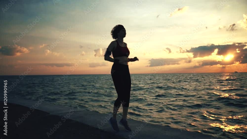 Runner athlete doing exersises at seaside Runner athlete doing exersises at seaside