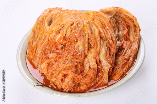 Korean cabbage kimchi on plate on white background