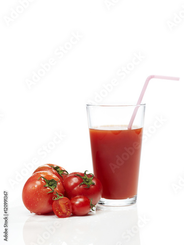 Tomato juice in glass on white background