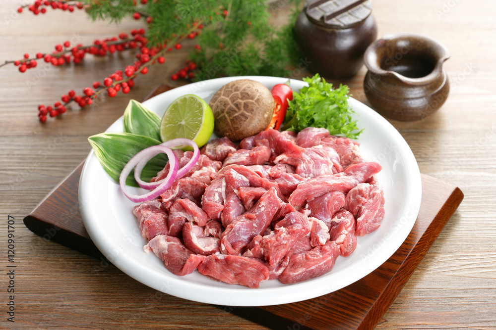 Skirt fresh steak on white plate with lemon, mushroom and herbs