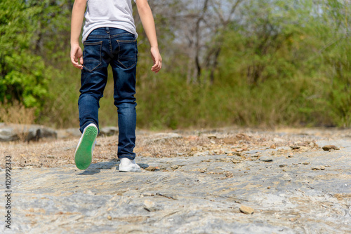 Boy walking on the rocky land. © TinPong