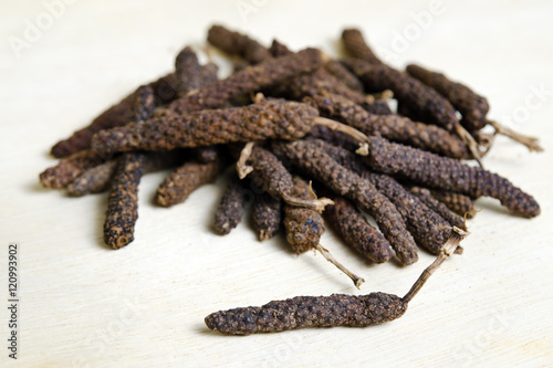 Long pepper or Pipli or Dipli (Piper longum) isolated on wood ba photo