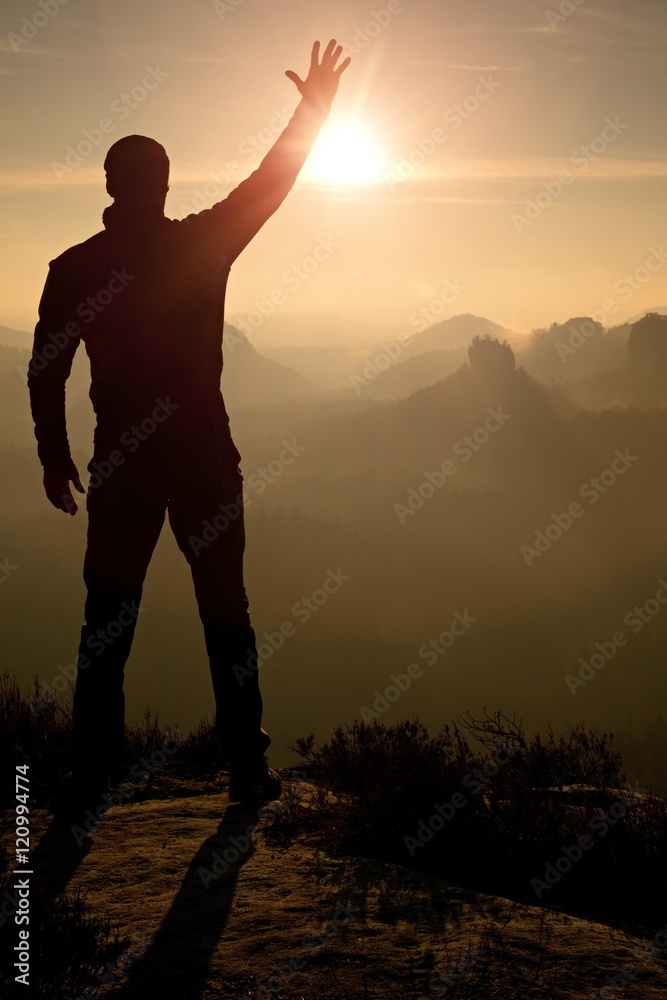 Fototapeta premium Man takes phone photos.Dreamy fogy mountains while sunrise