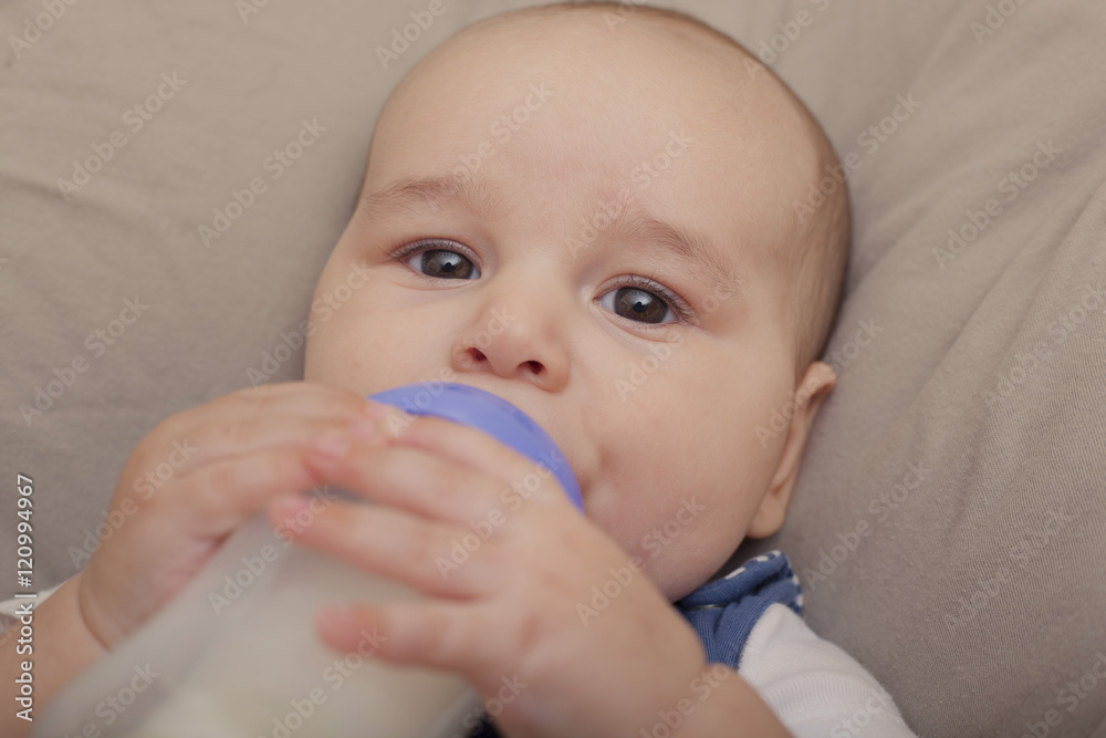 Baby boy drinking milk from the bottle Baby boy drinking milk from the bottle