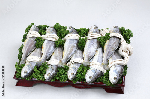 Glory set of gulbi fish on black plate in white background photo