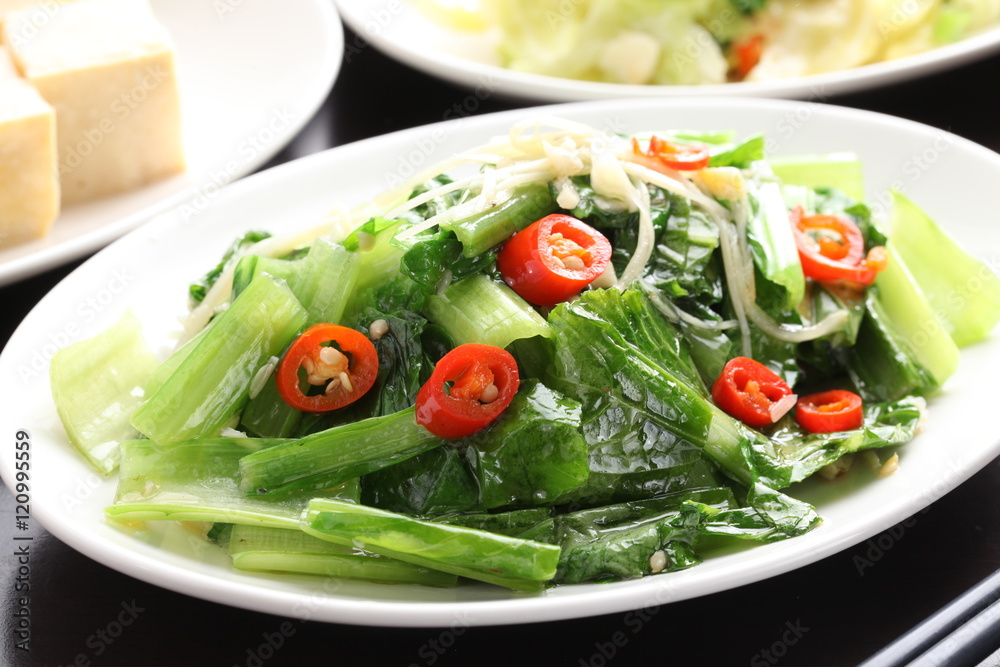 Seasonal vegetables with cabbage and chili on white plate Seasonal vegetables with cabbage and chili on white plate