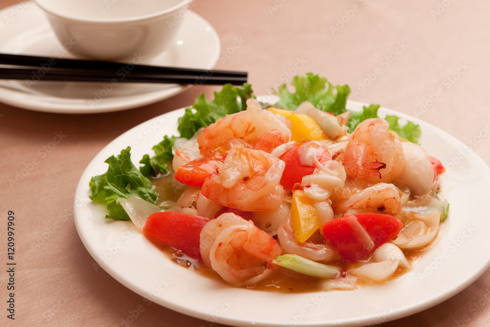 Fried lily shrimp with tomato and lettuce on white plate Fried lily shrimp with tomato and lettuce on white plate