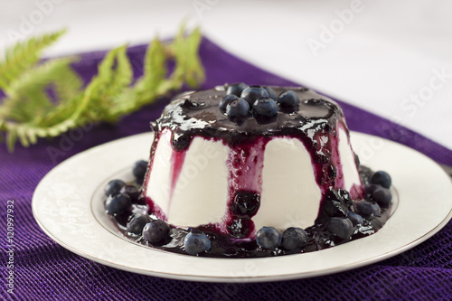 Sweet pudding with blueberry confiture photo