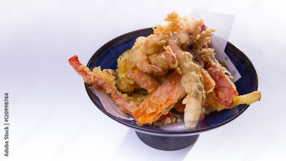 Tempura mix on blue chinese plate on white background Tempura mix on blue chinese plate on white background
