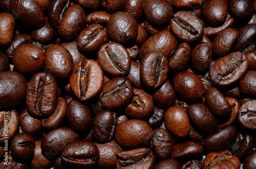 Fresh roasted coffee beans background, texture. Arabica bean wallpaper, close-up.