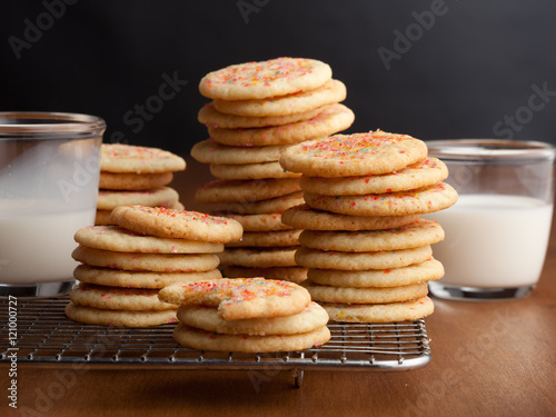 Chewy sugar cookies with glasses of milk on the table