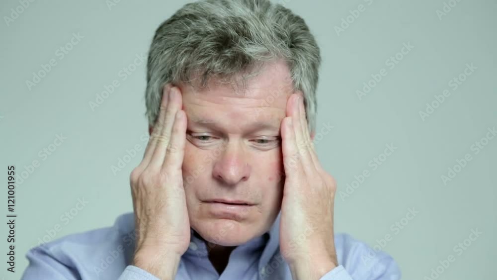 Man with headache rubs his head Man with headache rubs his head
