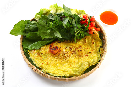 Vietnamese rice pancake or banh xeo with herbs and chili sauce o