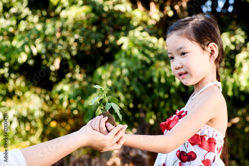 Child giving plant seedling