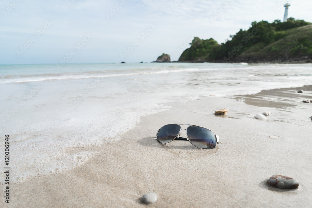 Sunglasses on the tropical beach with white sand Sunglasses on the tropical beach with white sand