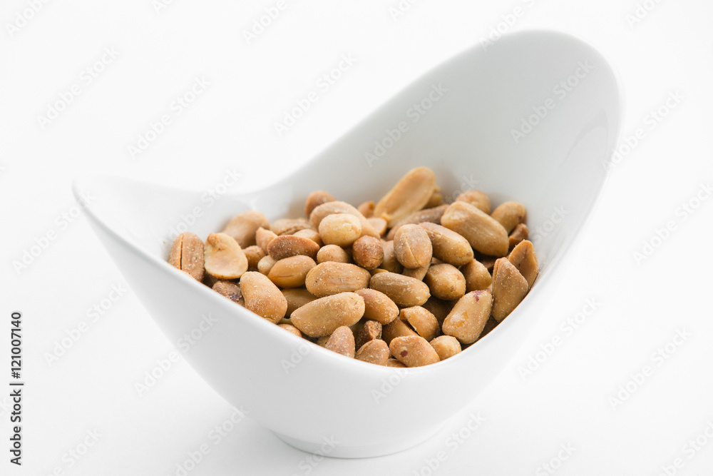 Fried peanuts in white bowl on white background Fried peanuts in white bowl on white background