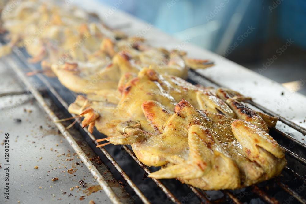 Roasting the whole chicken on the grill in asian restaurant Roasting the whole chicken on the grill in asian restaurant