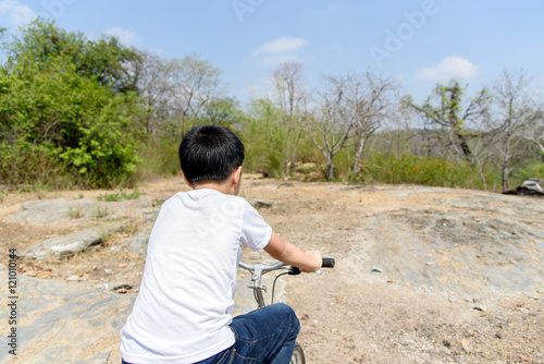 Little boy ride bicycle on the rock road. © TinPong