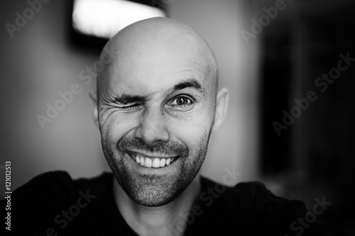brutal portrait of a happy bald man bristles