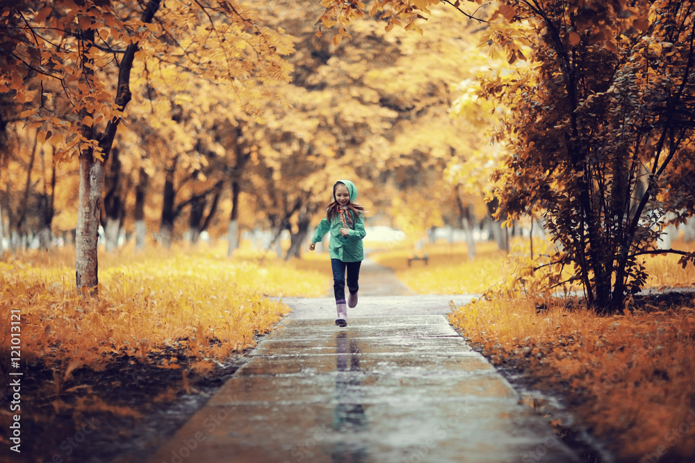 Girl 6-7 runs in the autumn park