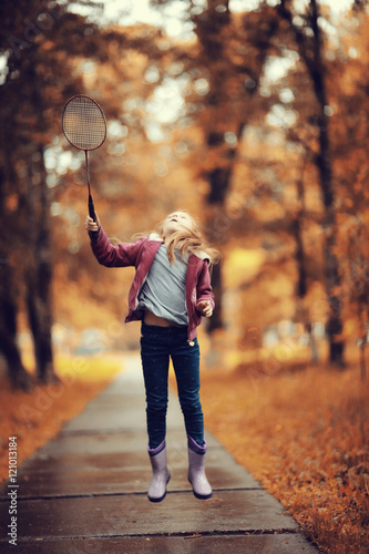 girl playing badminton in the park