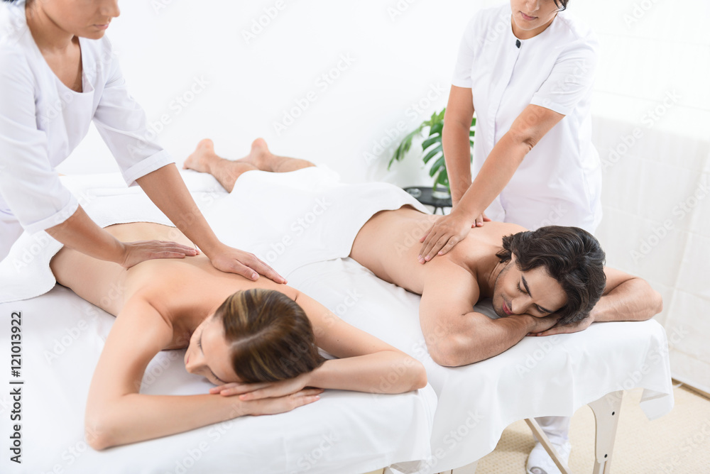 Fotografie Happy couple getting massage at spa