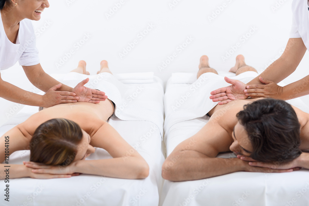 Fotografie Happy couple getting massage at spa