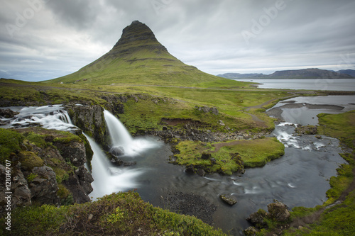  Waterfall with triangle mountain and gray sky in Iceland