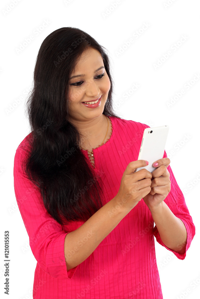 Happy young woman holding mobile photne and texting Happy young woman holding mobile photne and texting