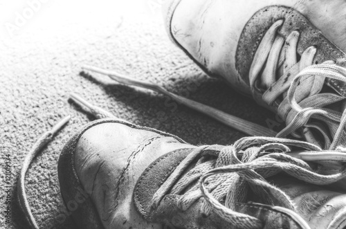 B/W closeup of worn, old sneakers grunge, retro style