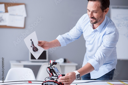 Happy scientist holding a prototype of his invention photo