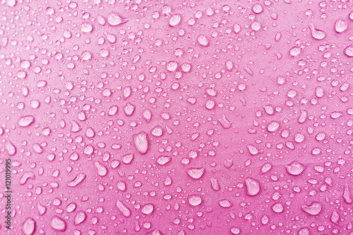 Water droplets on pink fiber waterproof fabric.