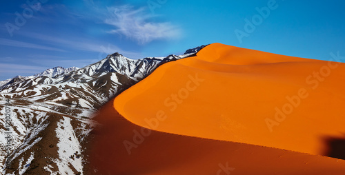 Concept of global warming. Morocco, High Atlas Mountains. Peak covered by snow. photo