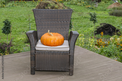 Mr. Pumpkin on the chair, preparing for Halloween