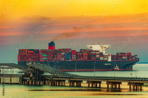Wallpaper Mural Tugboat assisting container ship on sea in the morning. Torontodigital.ca