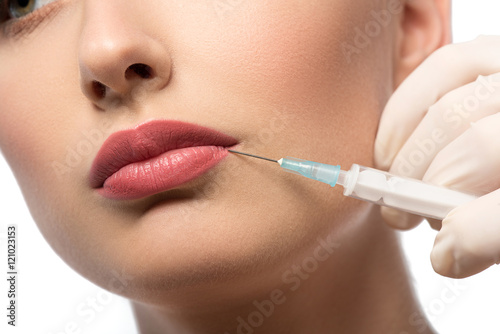 Beautiful young woman getting facial injection