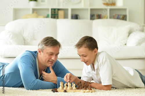 father and son playing chess