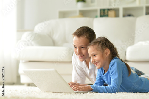 Children with laptop at home