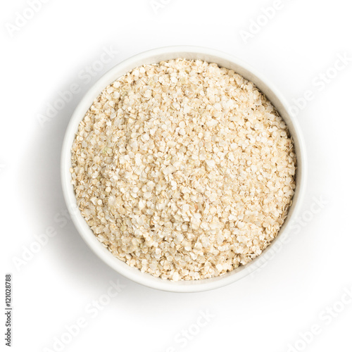 Quinoa Flakes into a bowl. Super Food. photo