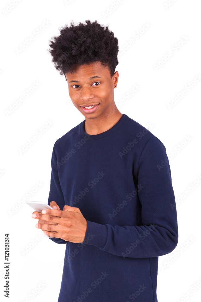 Young African American man sending a sms text message on his sma Young African American man sending a sms text message on his sma