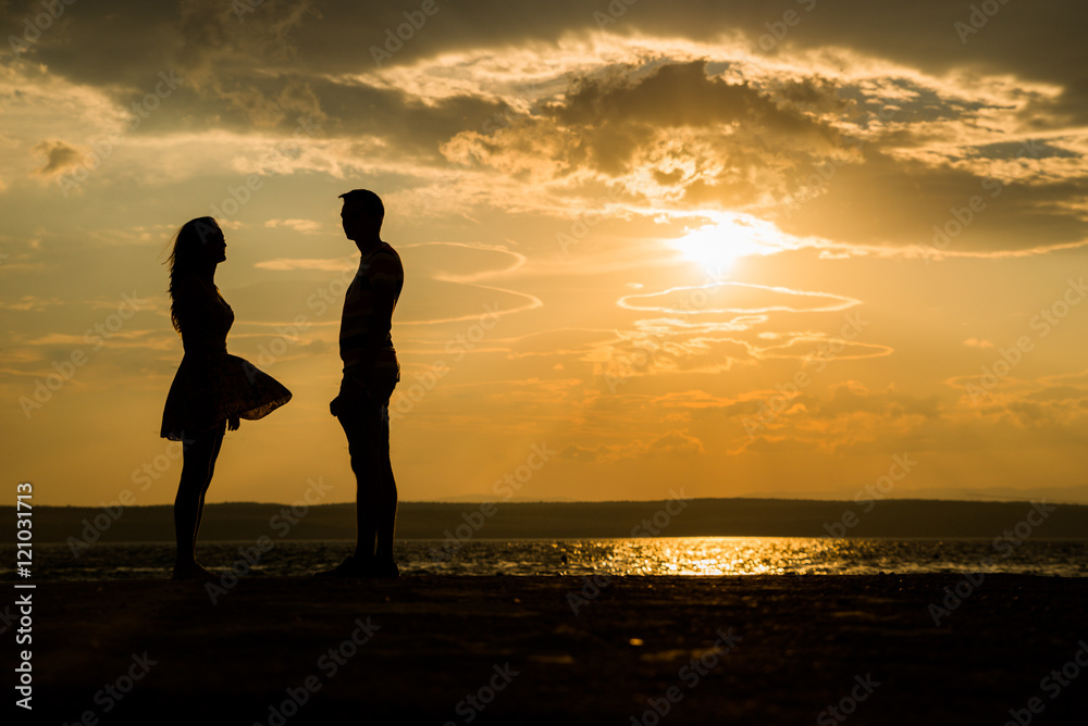 silhouette Romantic couple lovers standing facing each other at ...